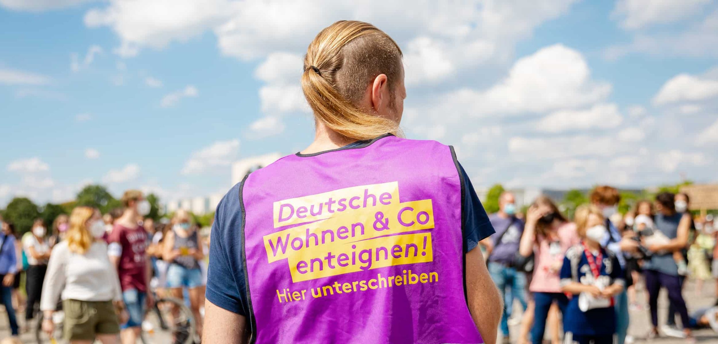 Aktivist für Initiative «Deutsche Wohnen & Co. enteignen» mit violetter Weste.
